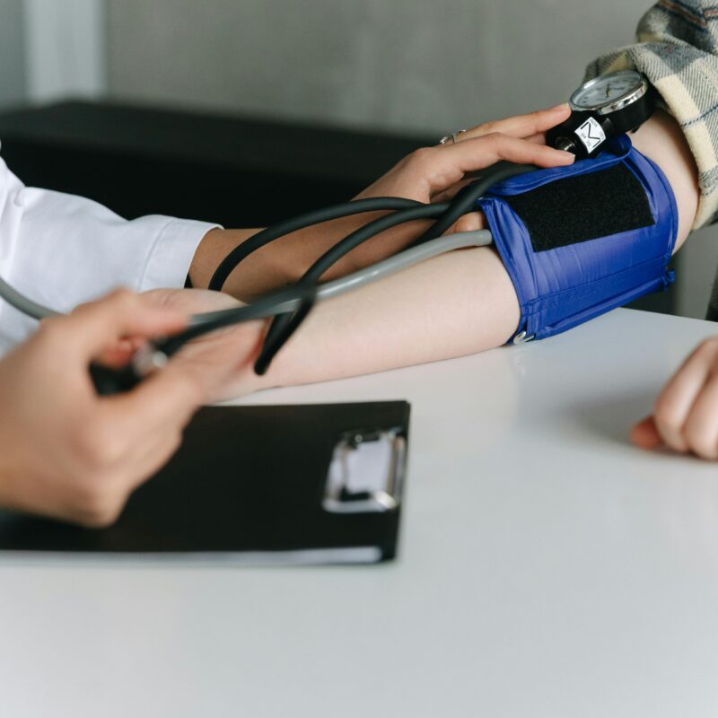 doctor checking patient's blood pressure
