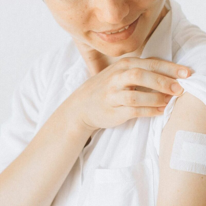 woman with band-aid on arm after a flu shot